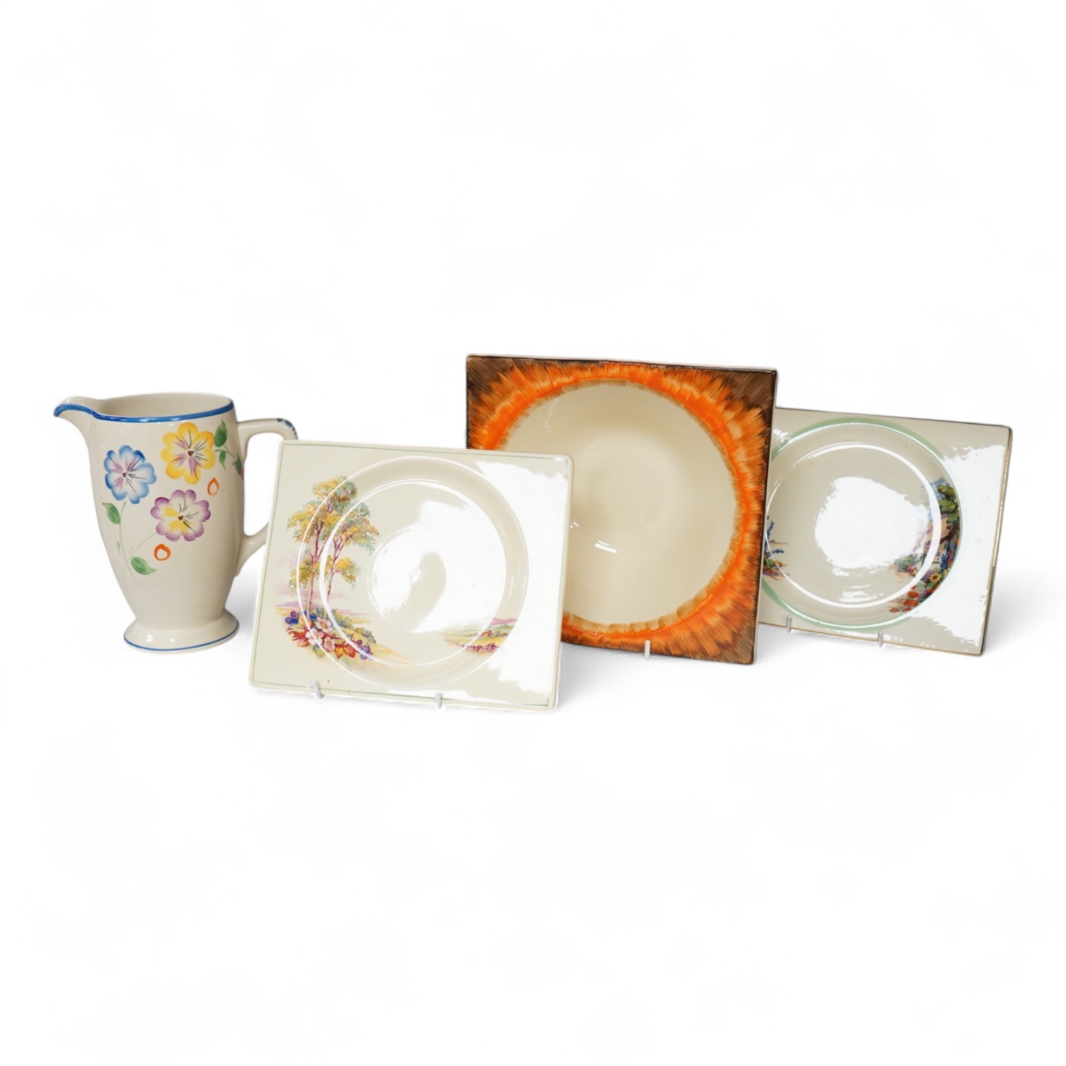 Three Clarice Cliff Bizarre ‘Biarritz’ dishes and a Wilkinson floral jug, largest 23cm wide